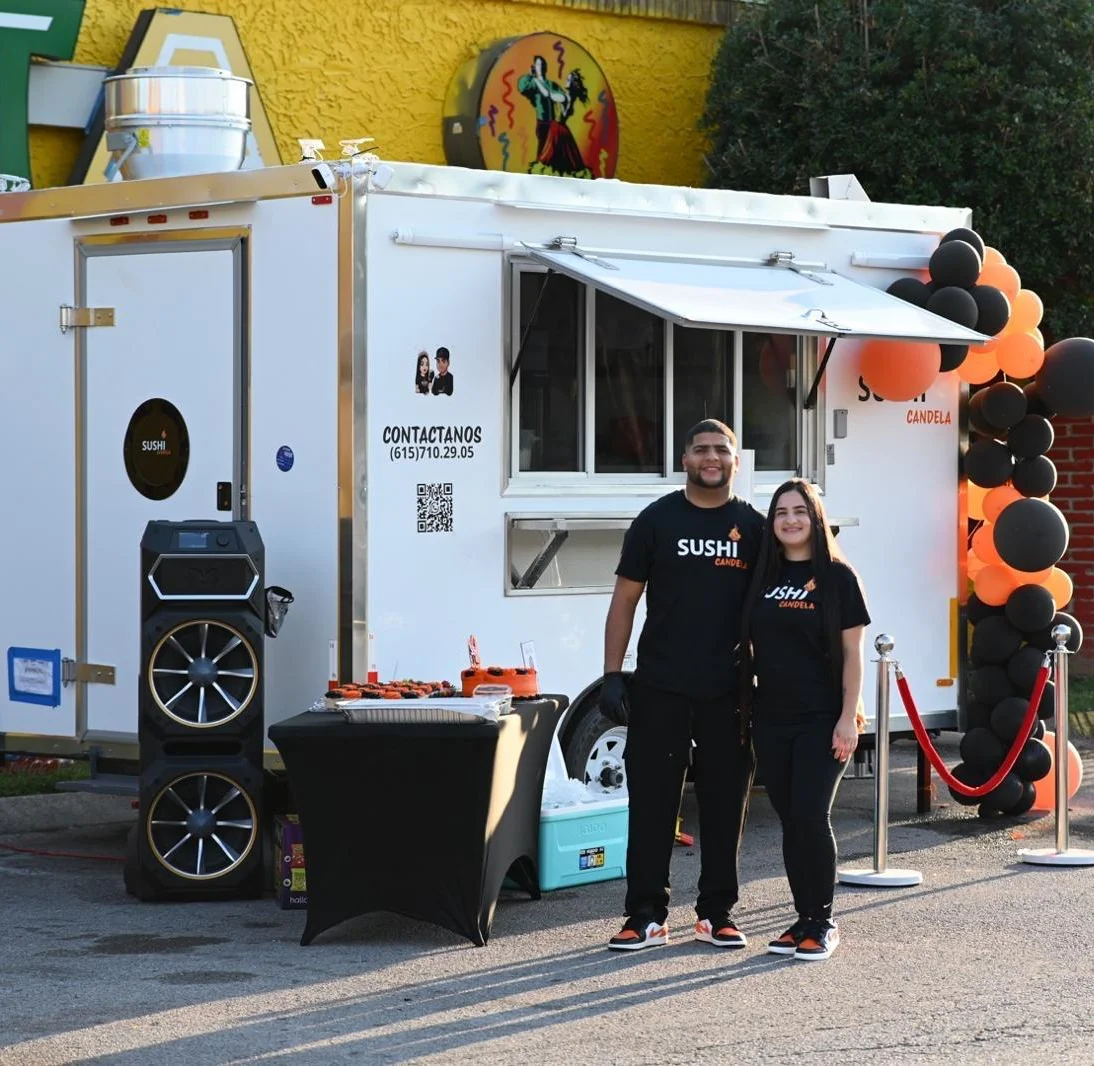 Sushi food truck with vibrant decor and staff