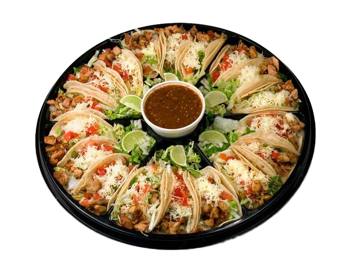 Platter of Mexican tacos with salsa and lime wedges