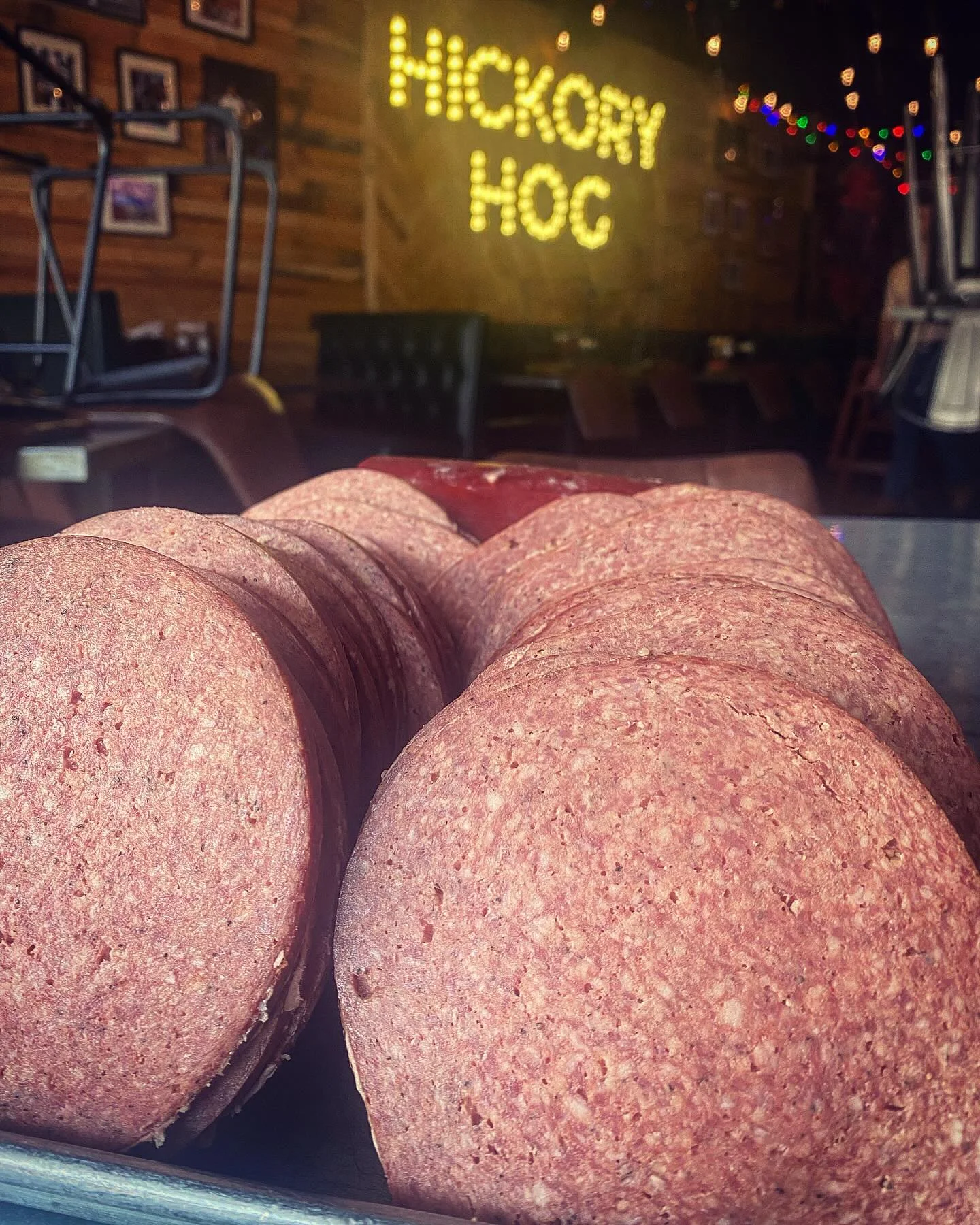 A close-up view of stacked slices of smoked meat, showcasing the texture and color.