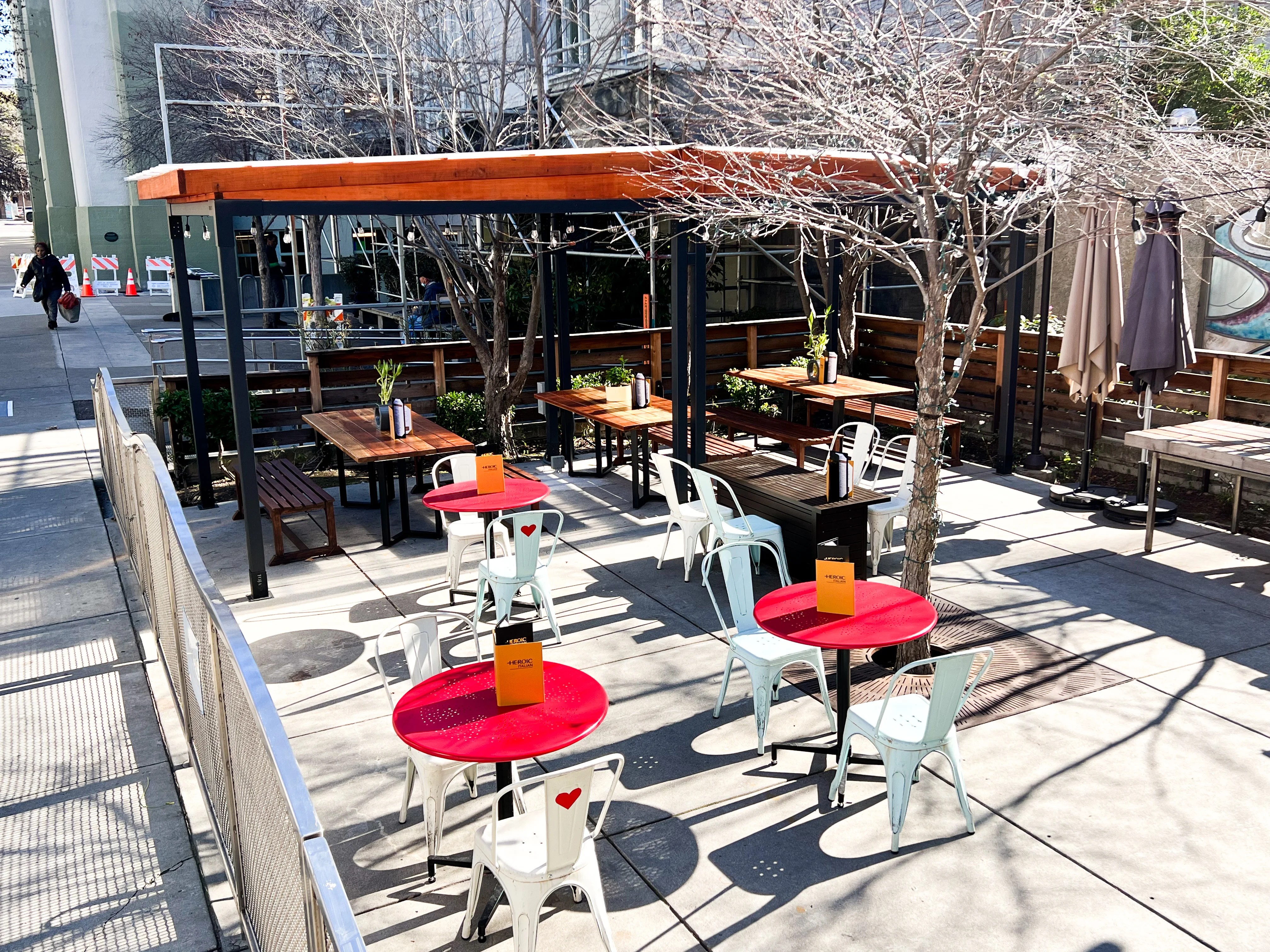Outdoor dining area with red tables and modern seating