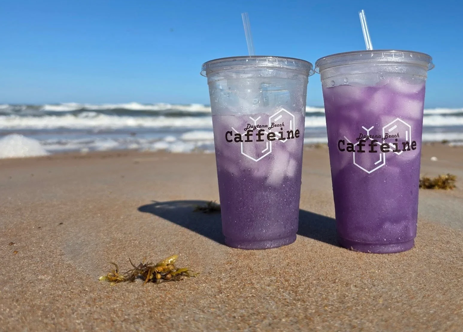 Refreshing purple iced drinks on a beach