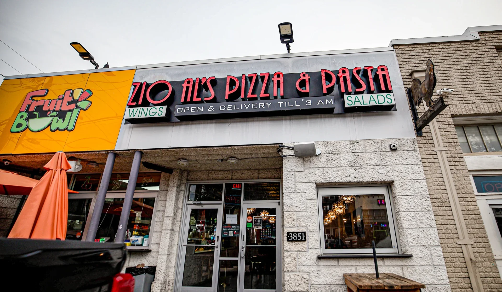 Exterior of Zio Al's Pizza & Pasta restaurant with neon signage