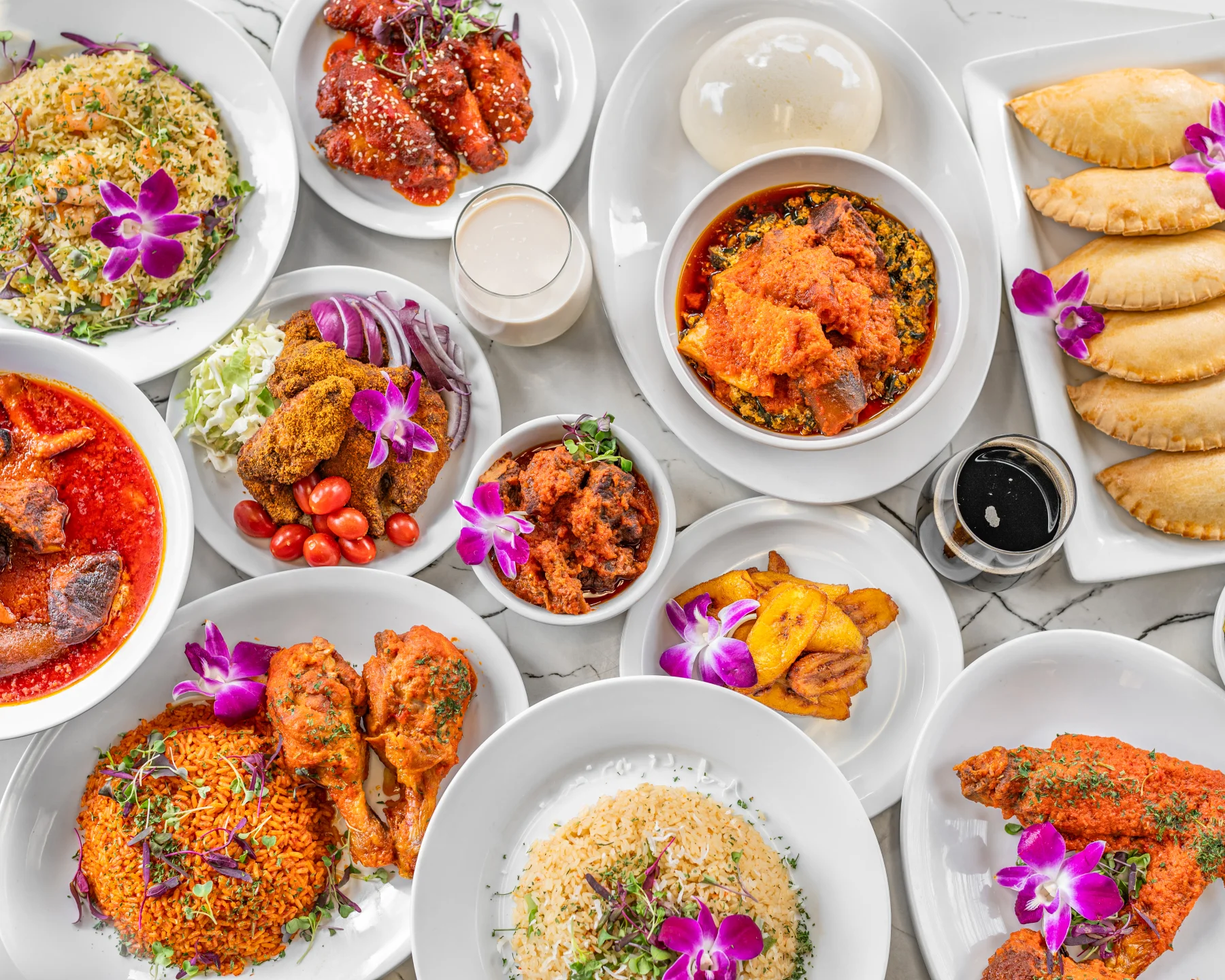 Assorted Nigerian dishes including jollof rice and fried plantains