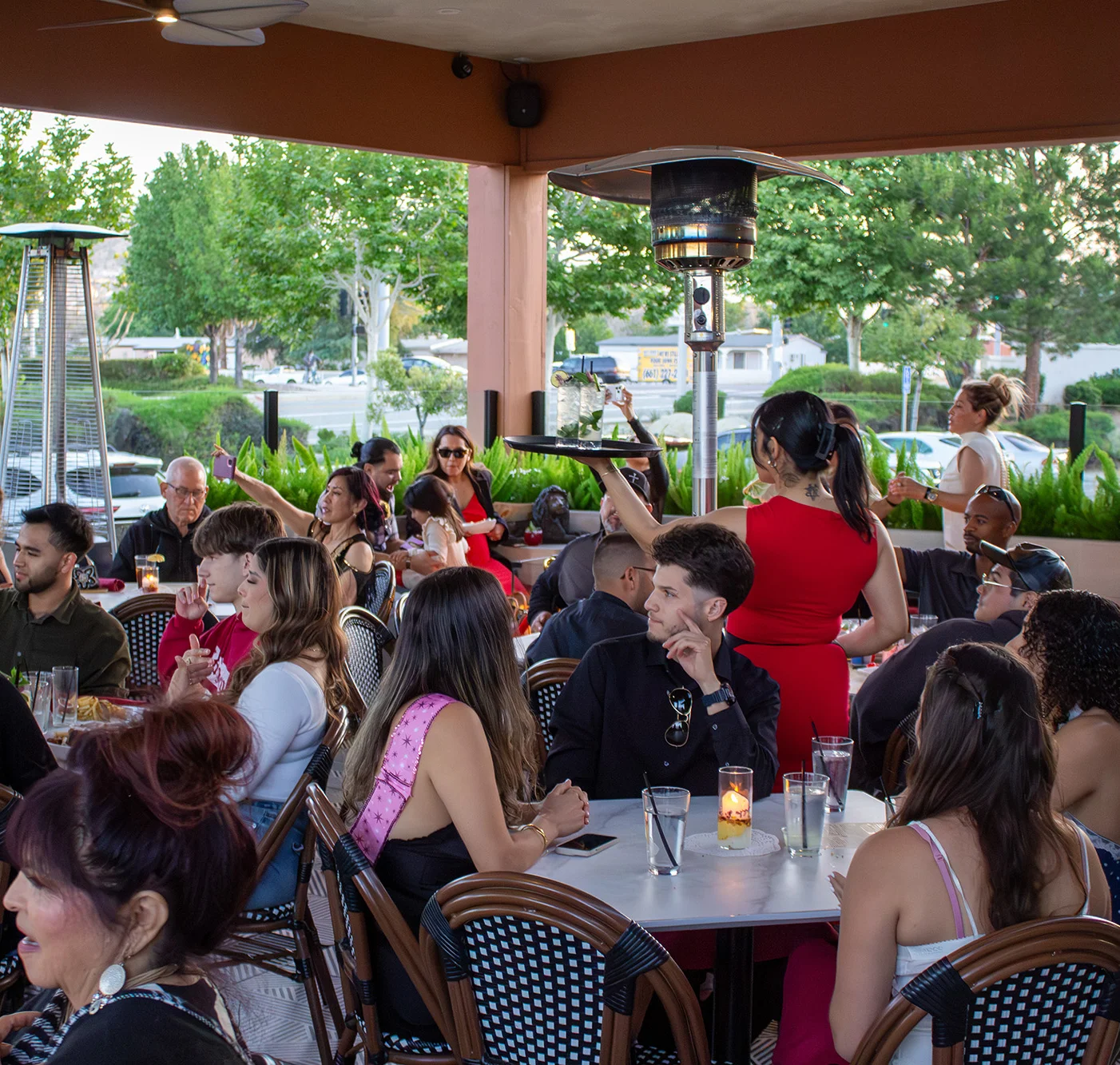 Lively restaurant patio filled with guests