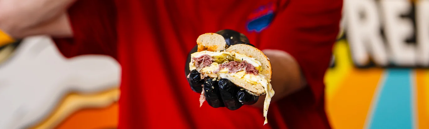 Delicious sandwich featuring a hearty filling, served in a vibrant eatery