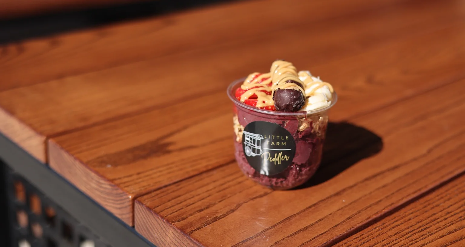 Acai bowl topped with fruits and drizzled peanut butter