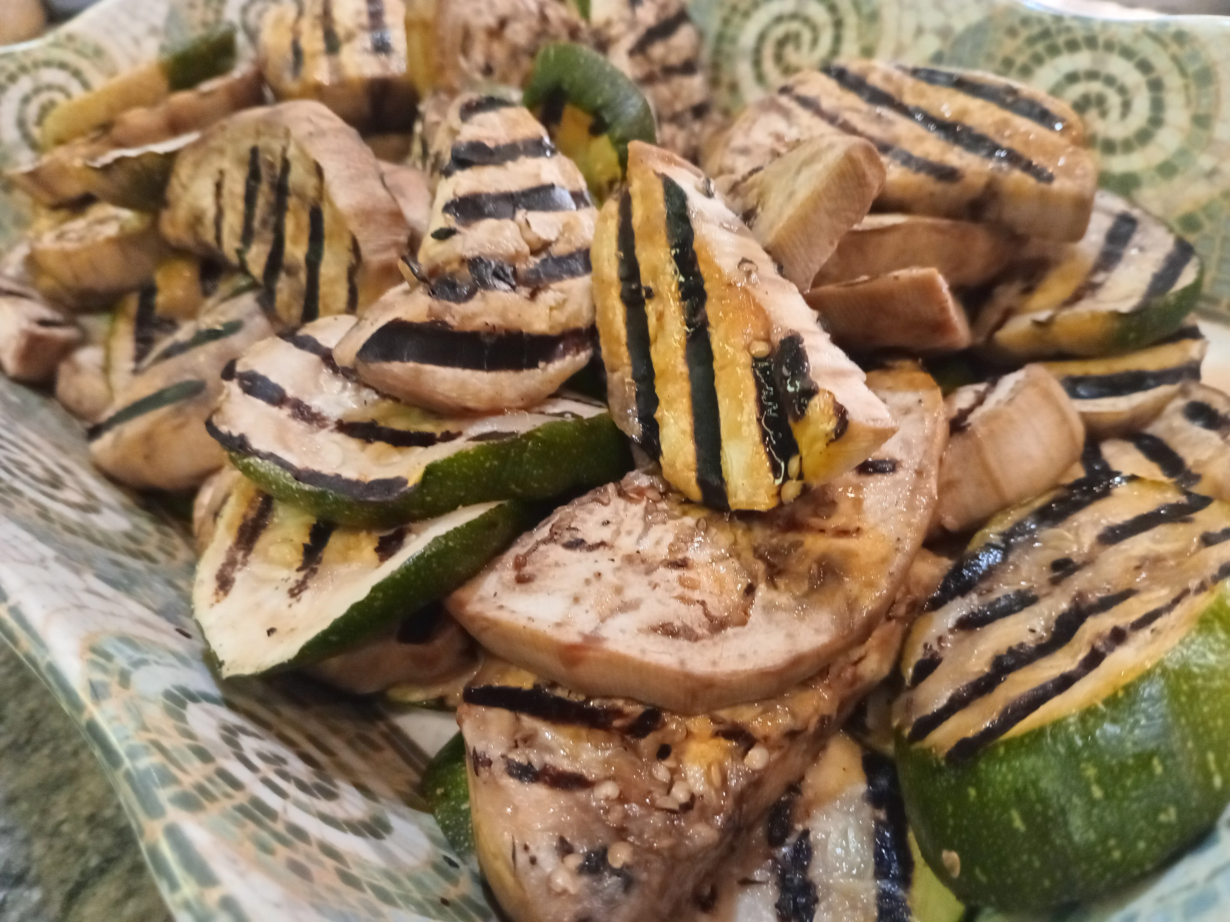 Grilled zucchini and eggplant slices on a decorative platter