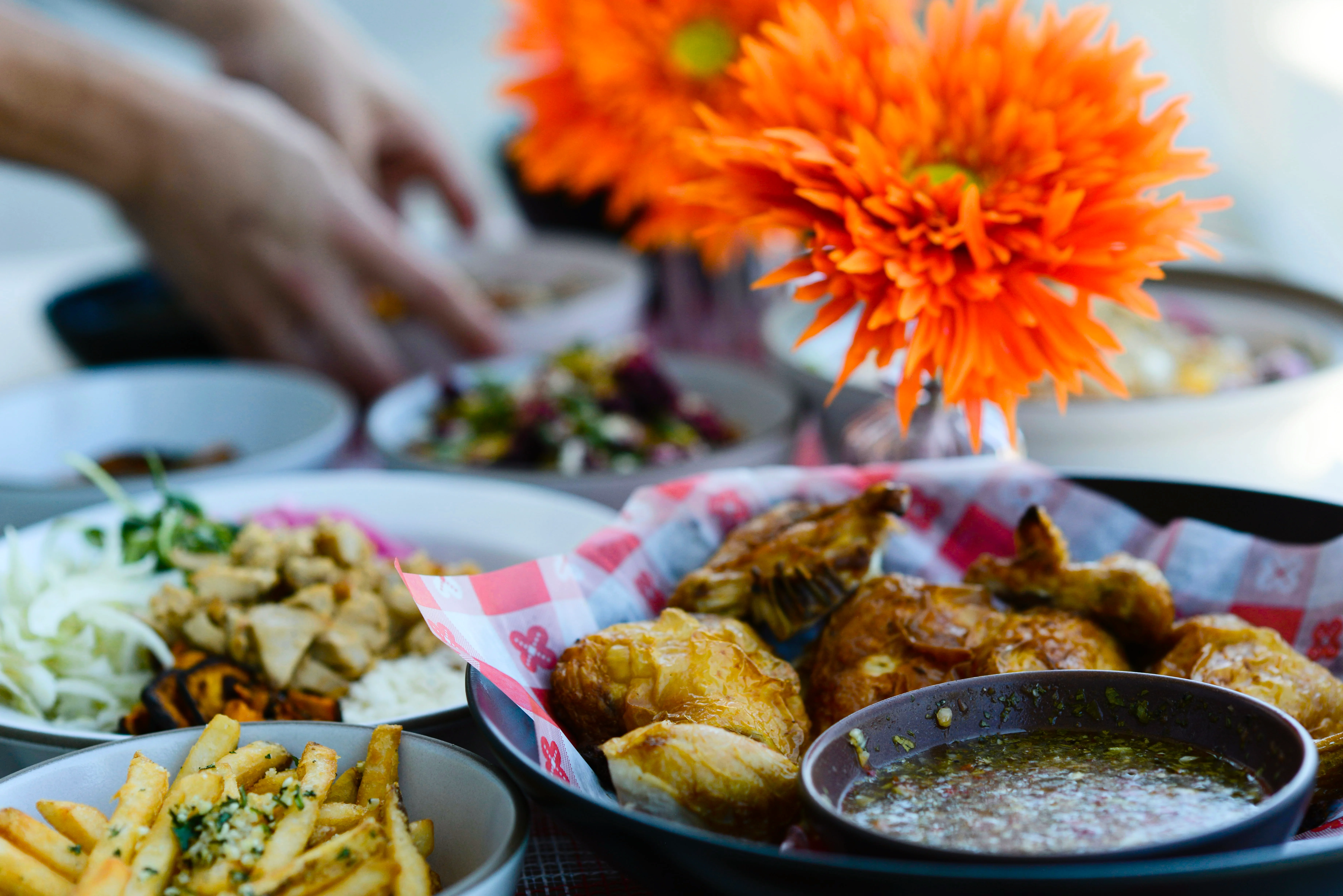 Crispy fried chicken with dipping sauce and sides in a vibrant setting
