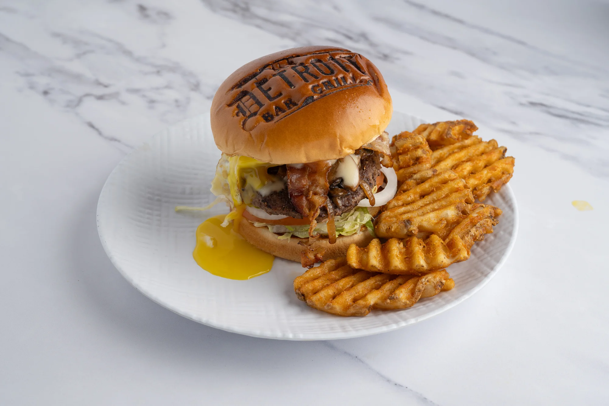 Juicy American cheeseburger with waffle fries