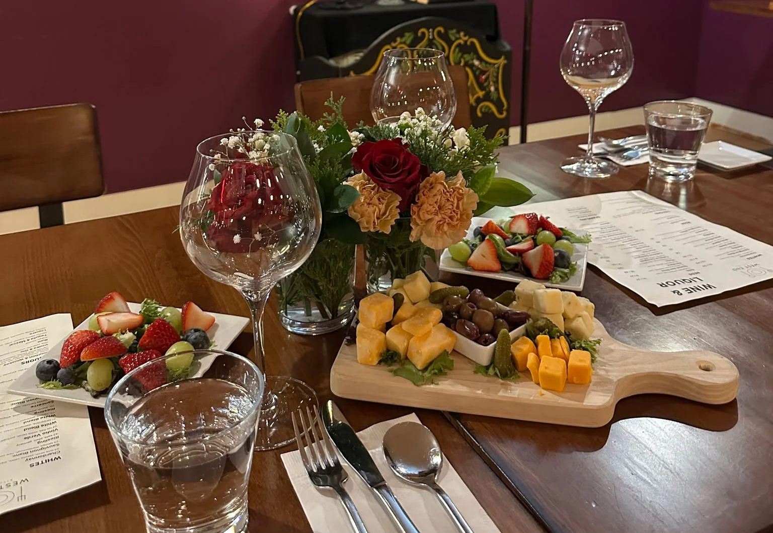 Charming restaurant interior with cheese platter and floral centerpiece