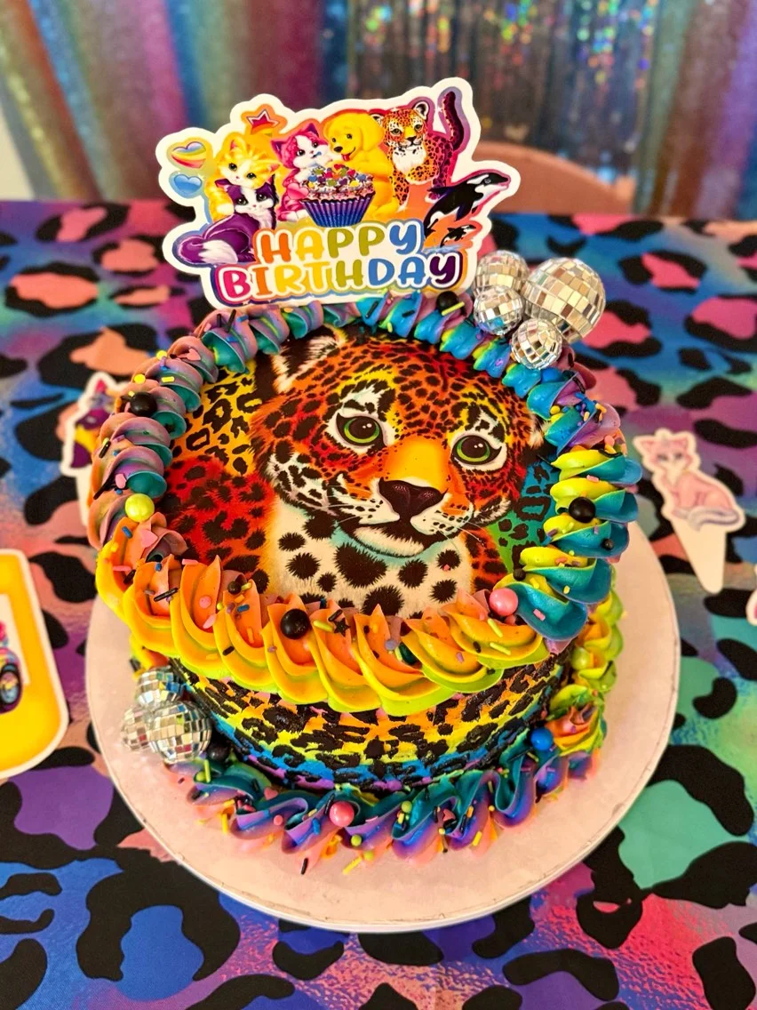 Colorful birthday cake with leopard design and festive decorations