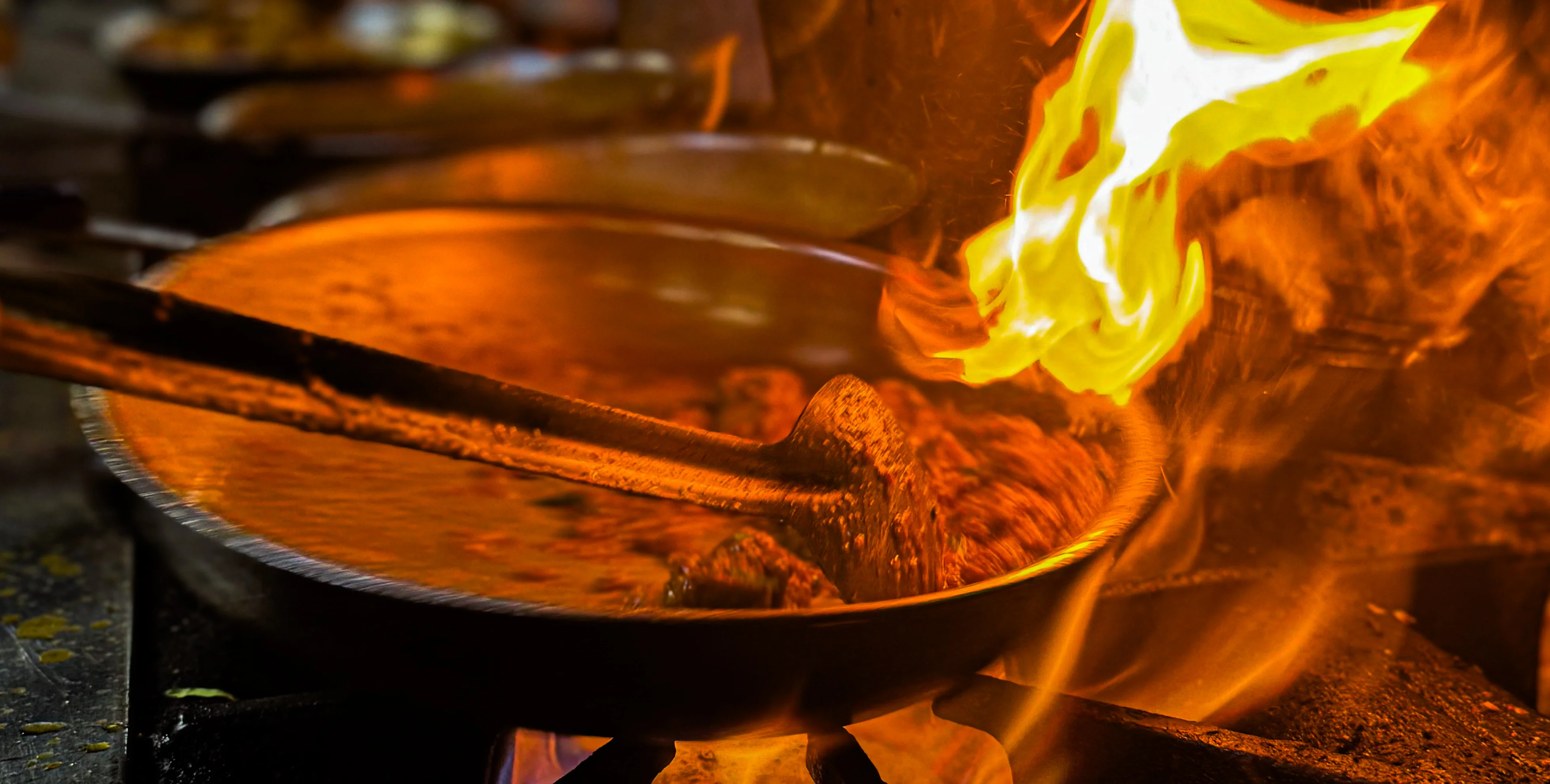 Flambé cooking technique in a busy restaurant kitchen
