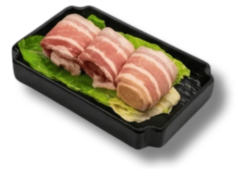 Three rolls of bacon on lettuce in a black tray.