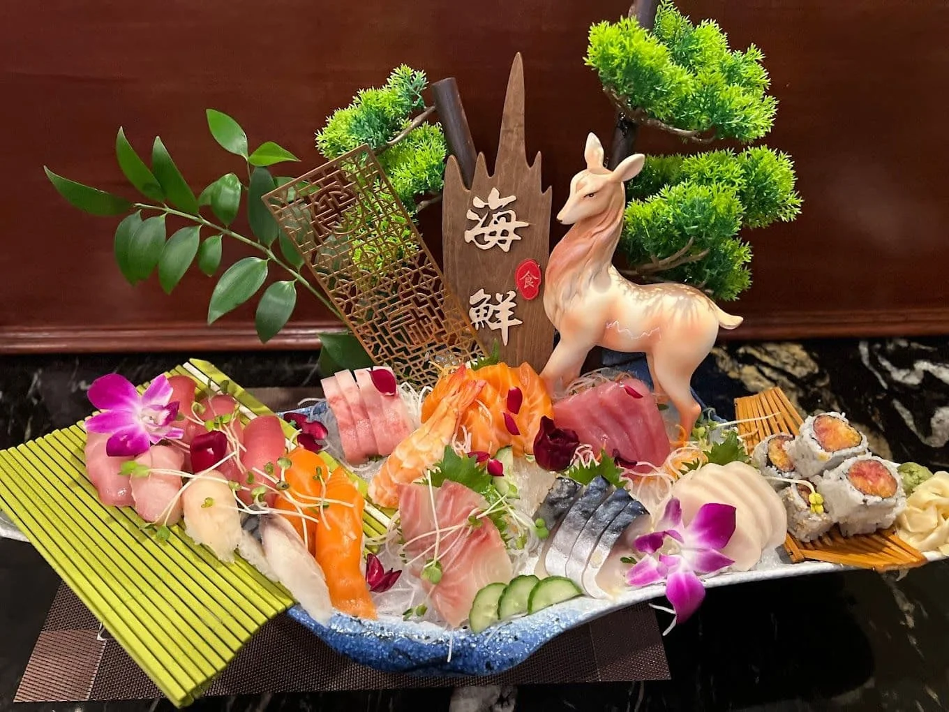 Artfully arranged Japanese sashimi platter with decorative elements
