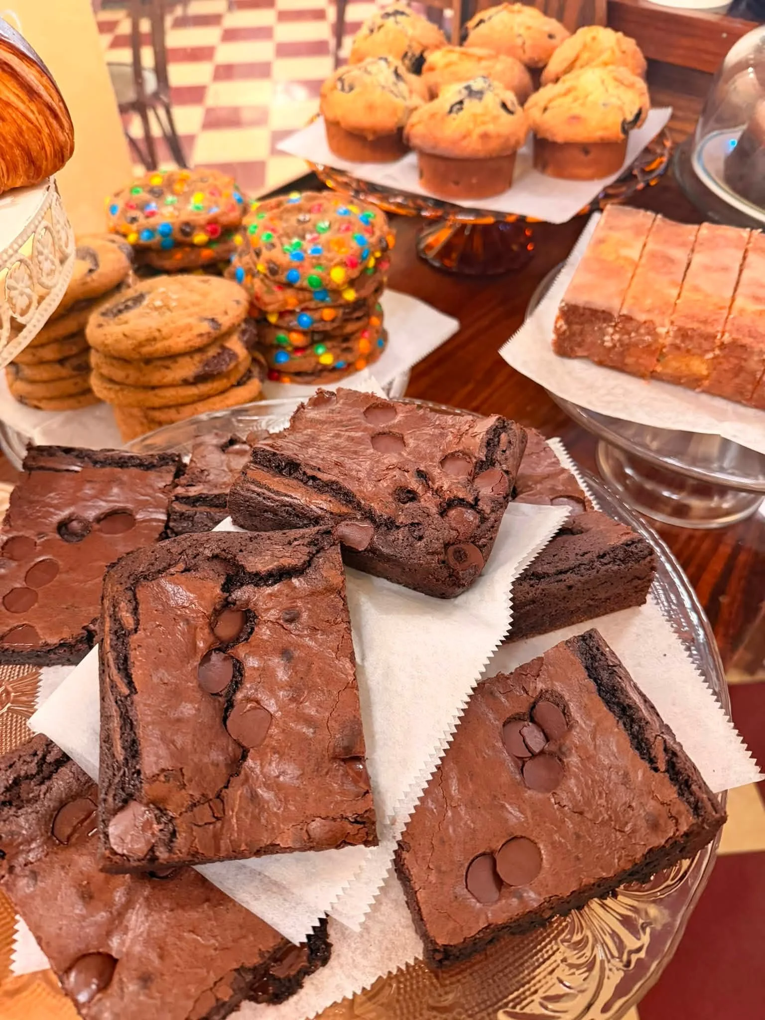 Assorted brownies and cookies on a dessert display