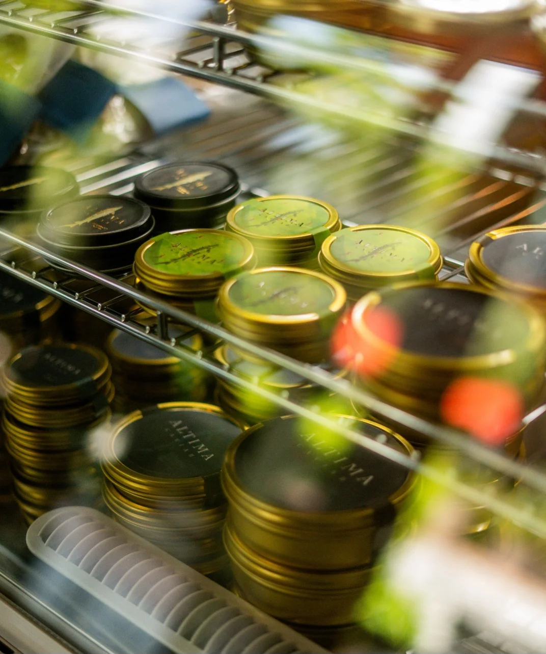 Assorted gourmet tins displayed in a modern cafe