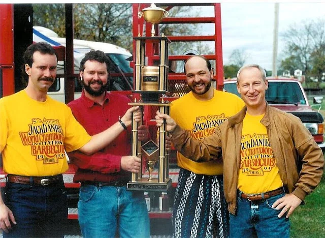 Barbecue competition winners holding trophy