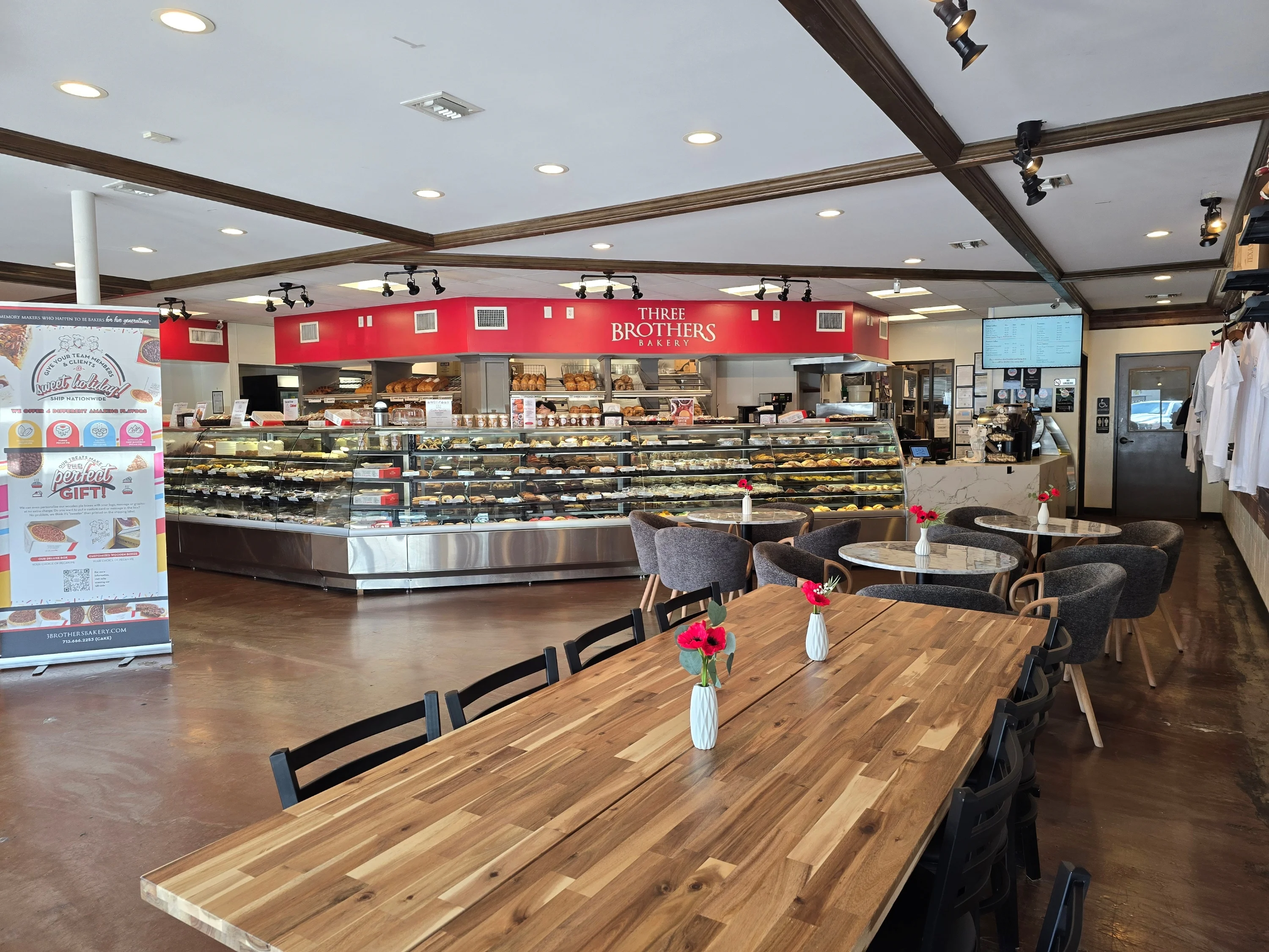 Cozy bakery interior with display cases and wooden tables