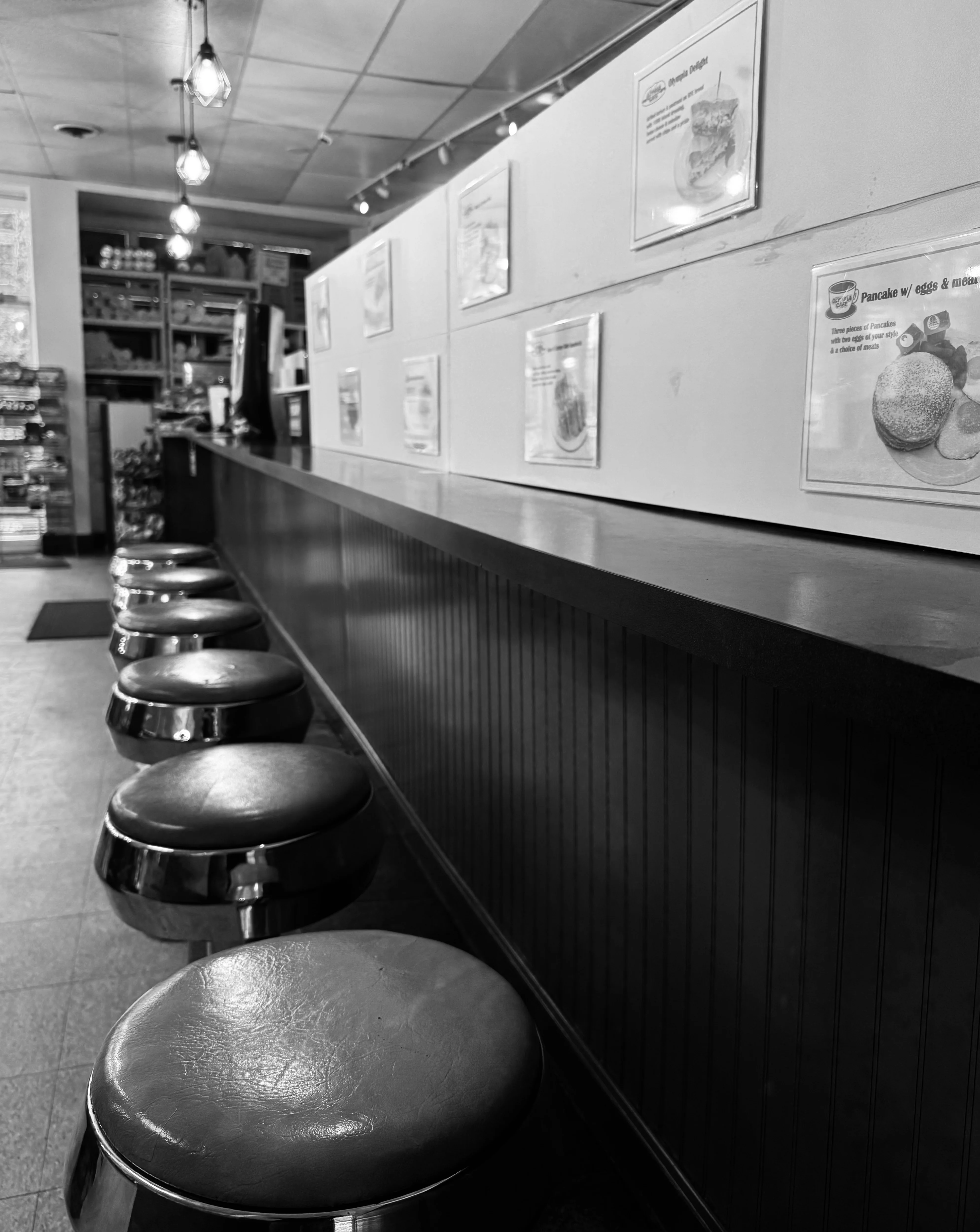 Cozy diner interior with chrome stools and menu displays