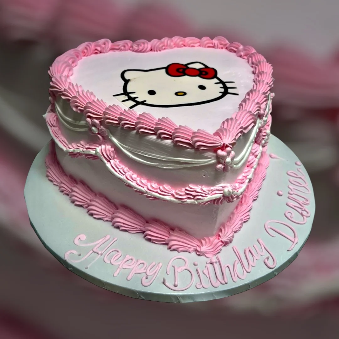 Heart-shaped Hello Kitty birthday cake with pink frosting