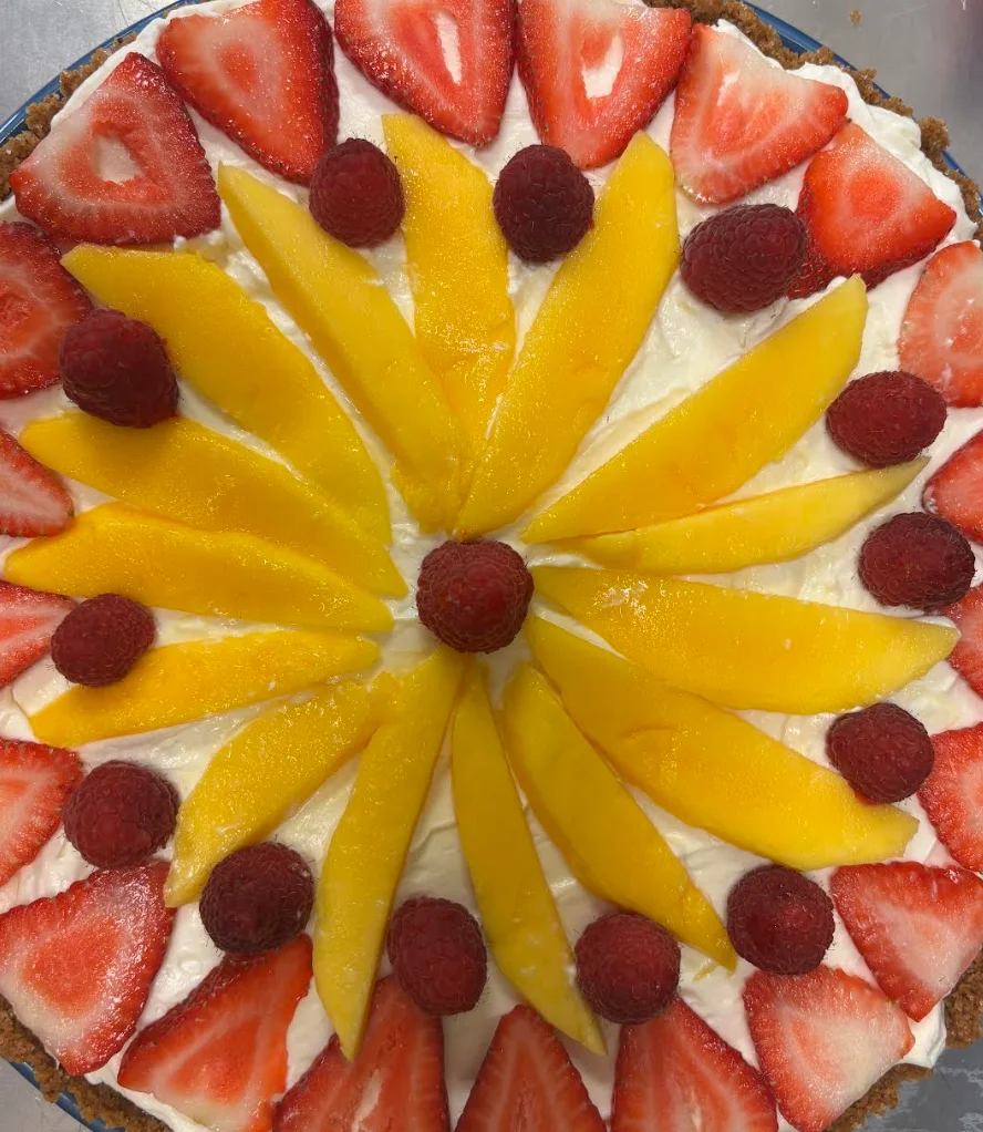 Colorful fruit tart with strawberries and mango