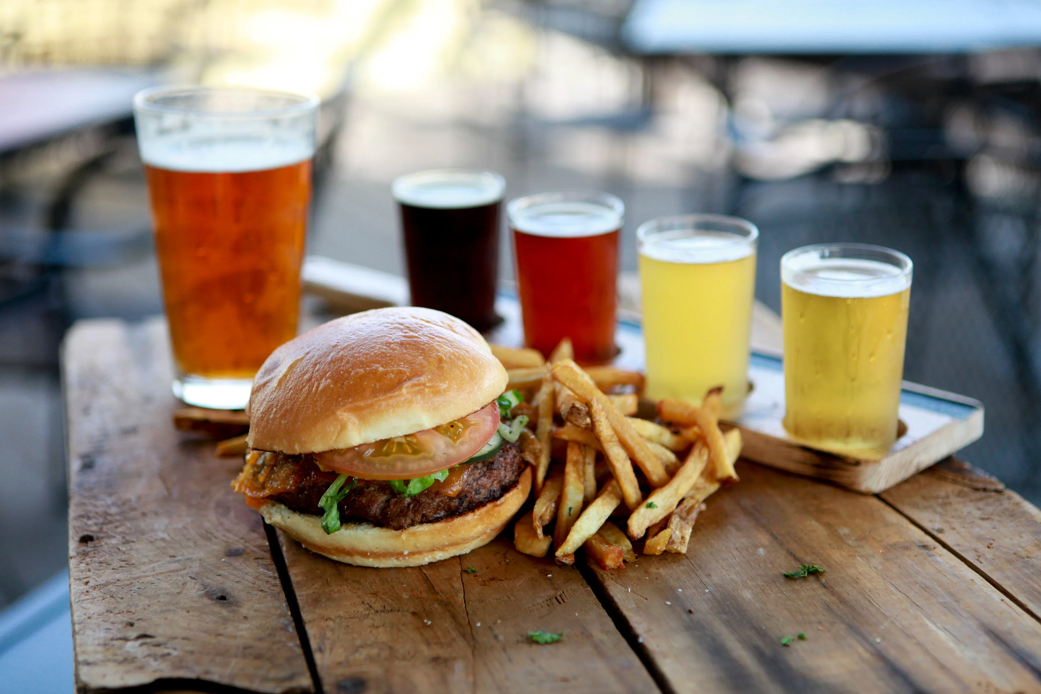 Juicy American cheeseburger with fries and craft beer flight