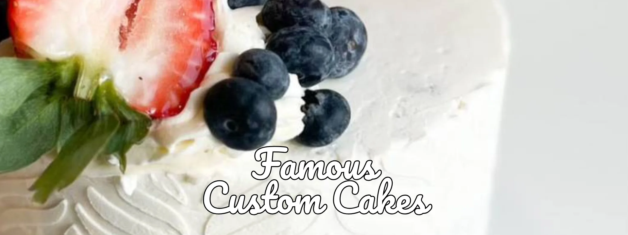 Custom cake decorated with fresh strawberries and blueberries
