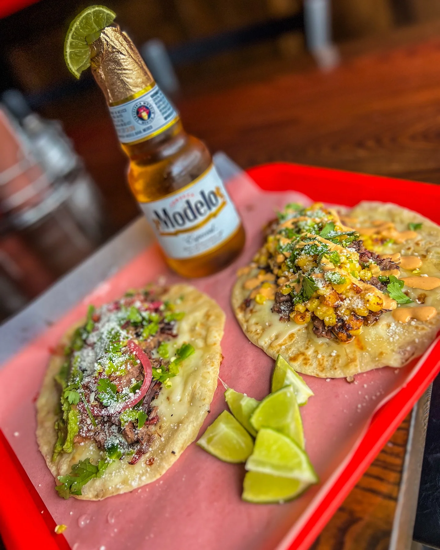 Delicious Mexican tacos with beer and lime wedges
