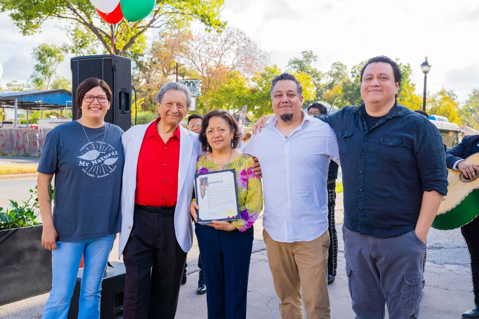 Group celebrating a community event with awards and recognition