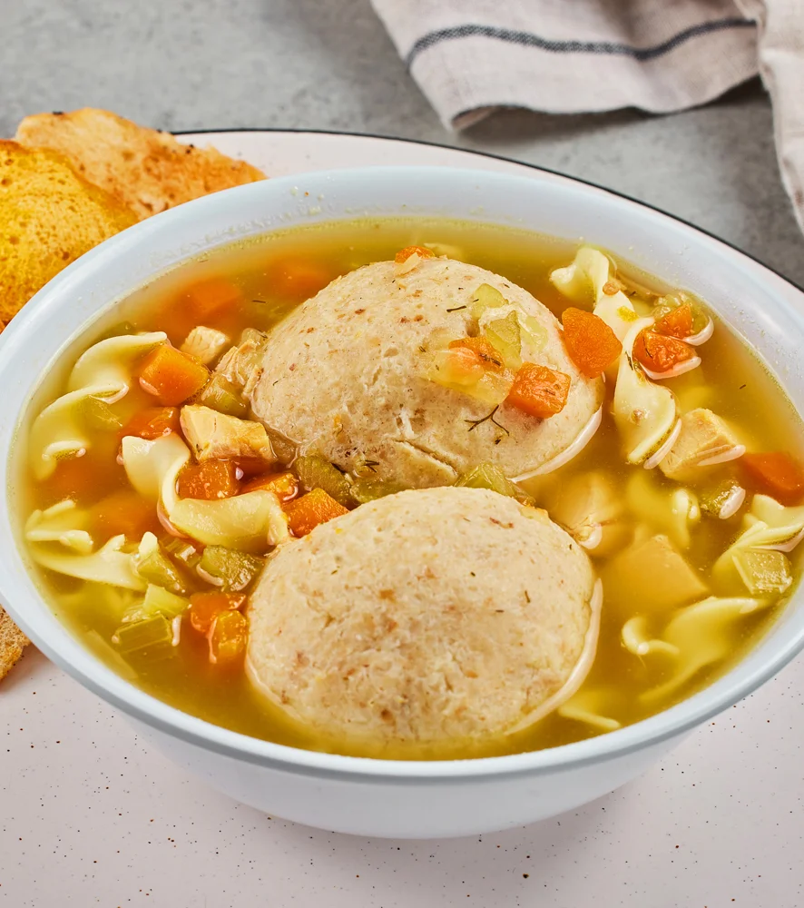 Chicken matzoh ball soup with noodles and vegetables