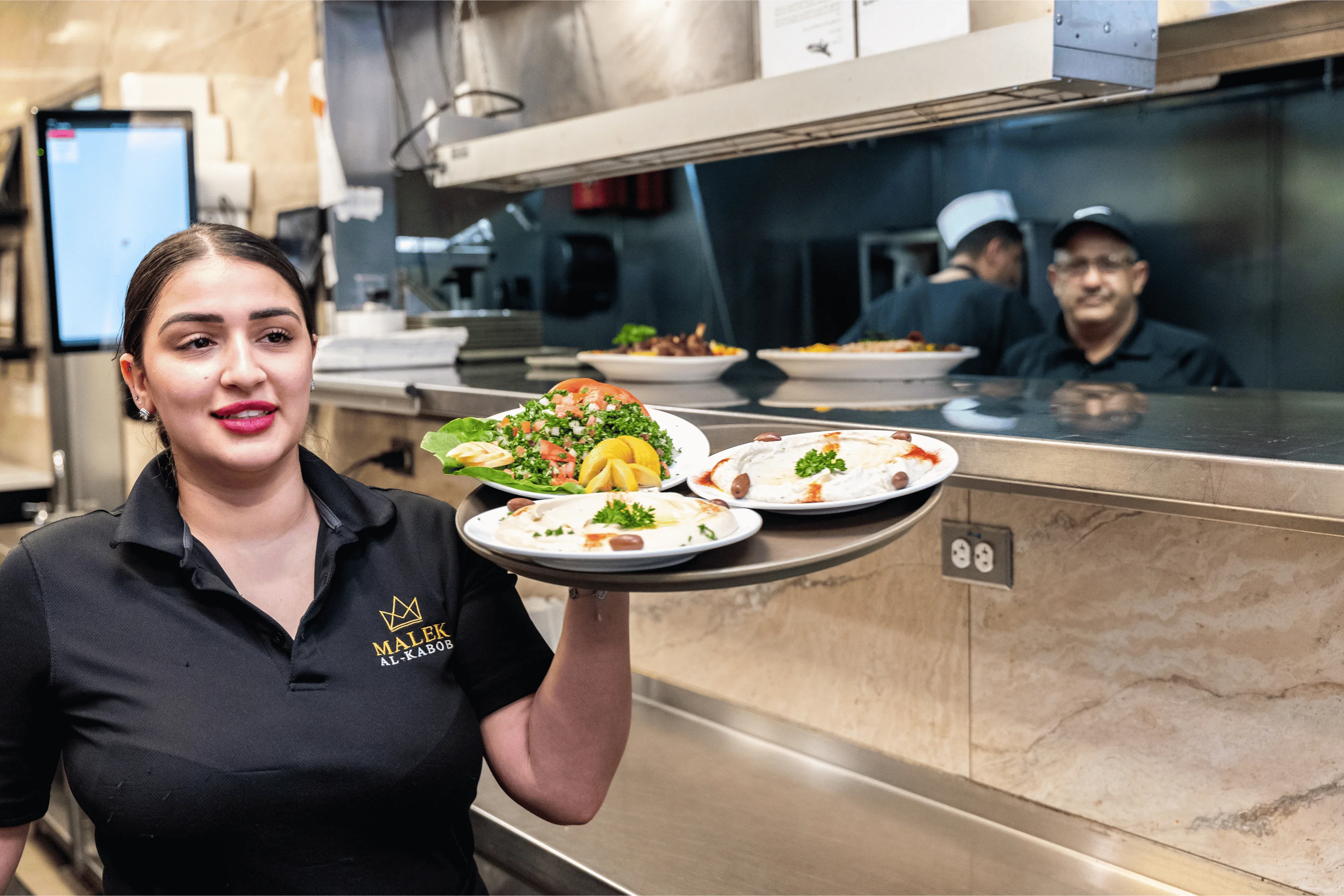 Staff providing friendly service at Malek Al Kabob
