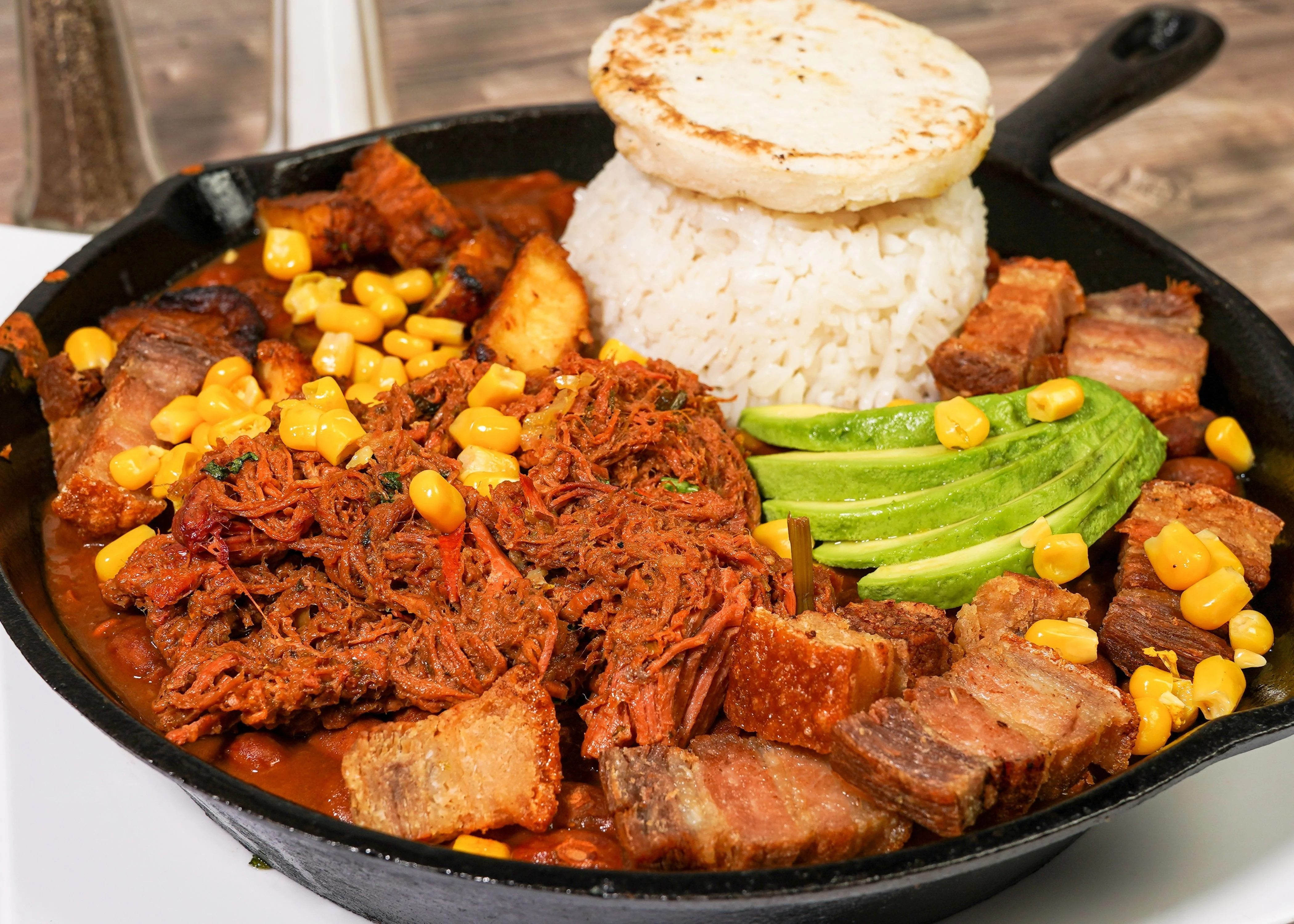 Hearty Venezuelan pabellón criollo served in a cast iron skillet