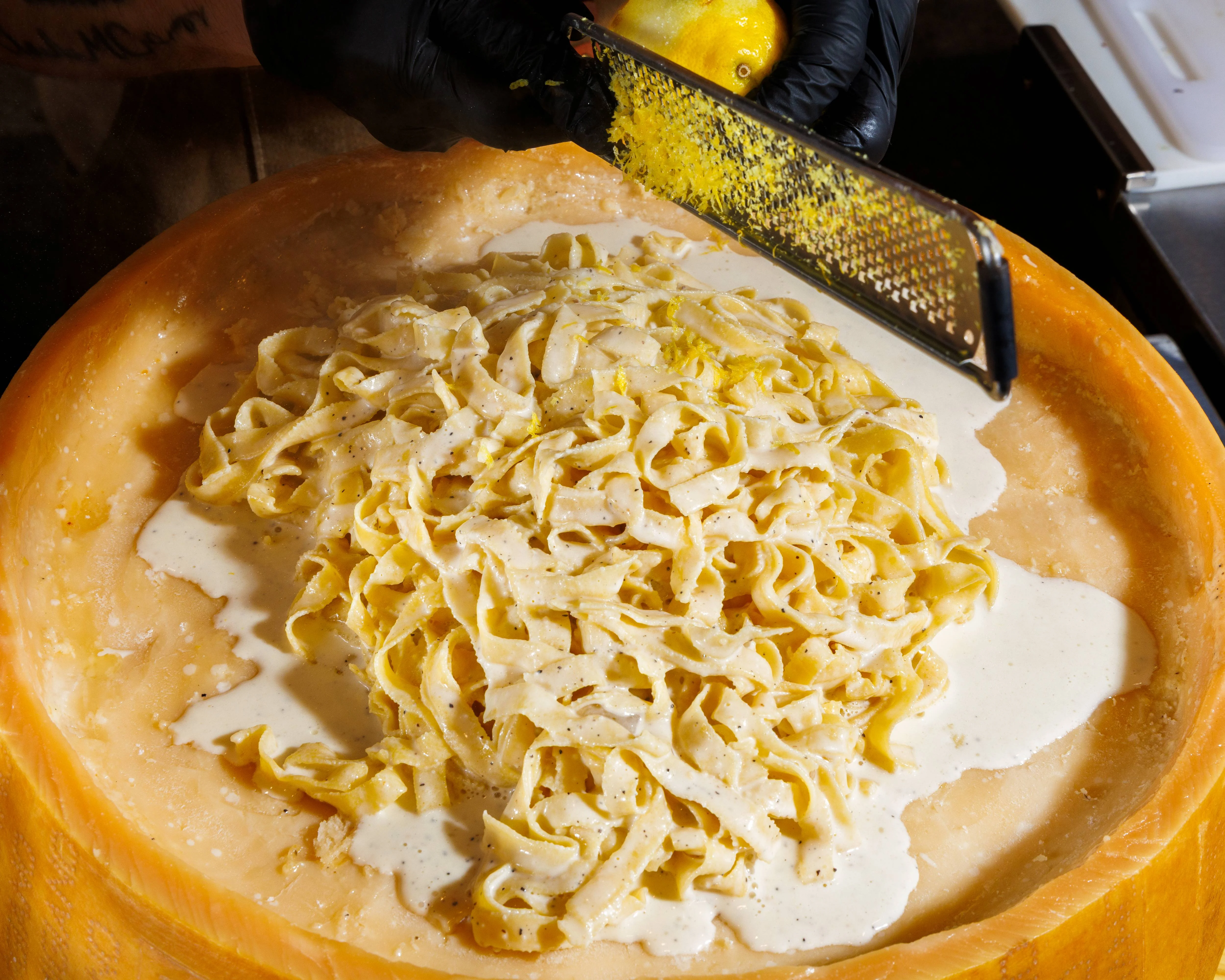 Assorted Italian pasta dishes and sandwiches on a white table