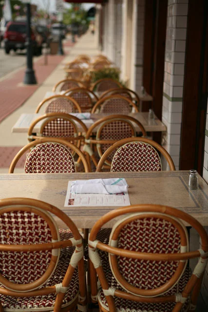 Charming outdoor dining area with wicker chairs and tables