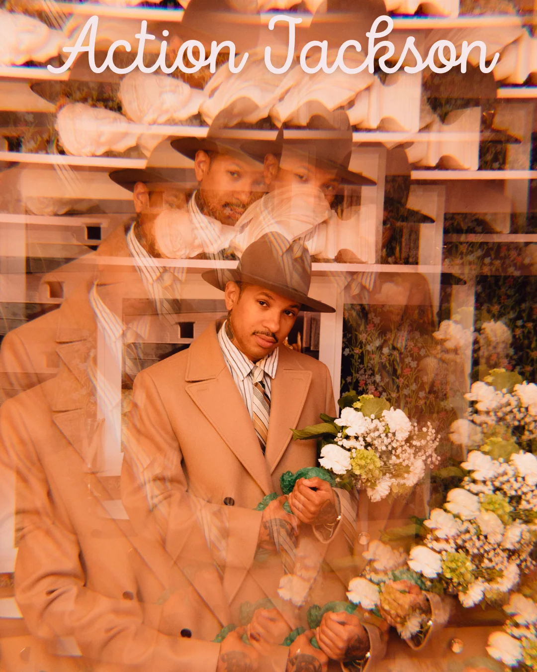 Stylish individual in a tan coat holding flowers