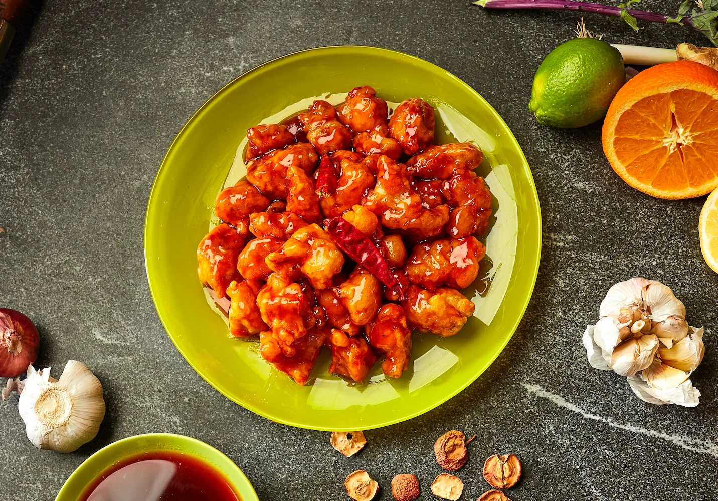 Sweet and sour chicken served on a vibrant green plate