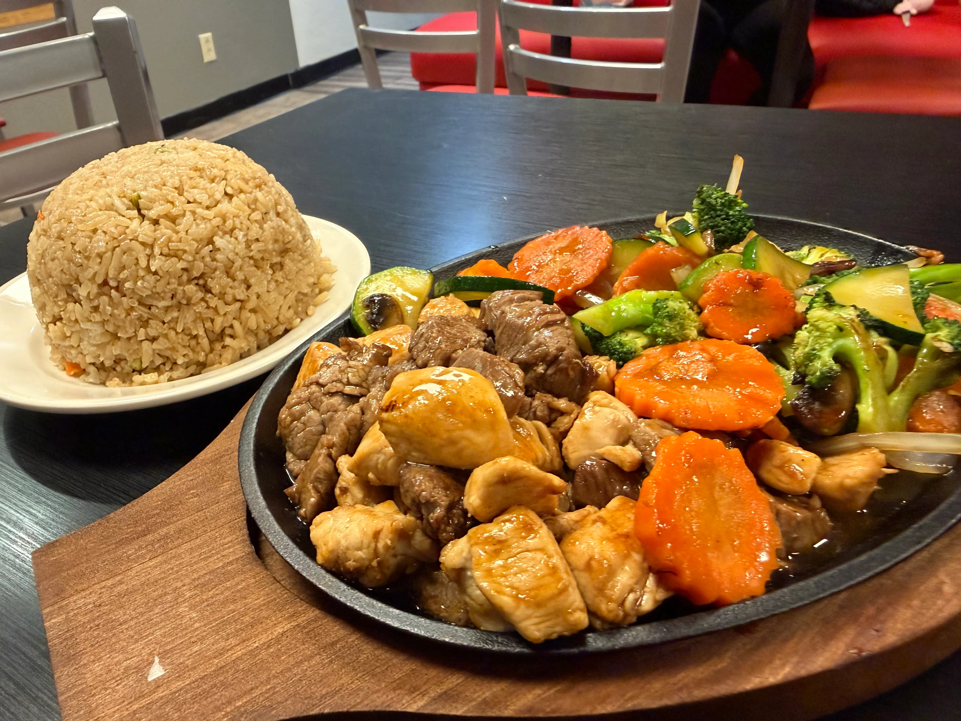 Sizzling chicken and beef stir-fry with fried rice