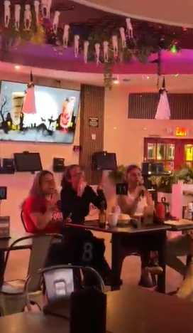 Lively restaurant scene with guests enjoying a meal and entertainment