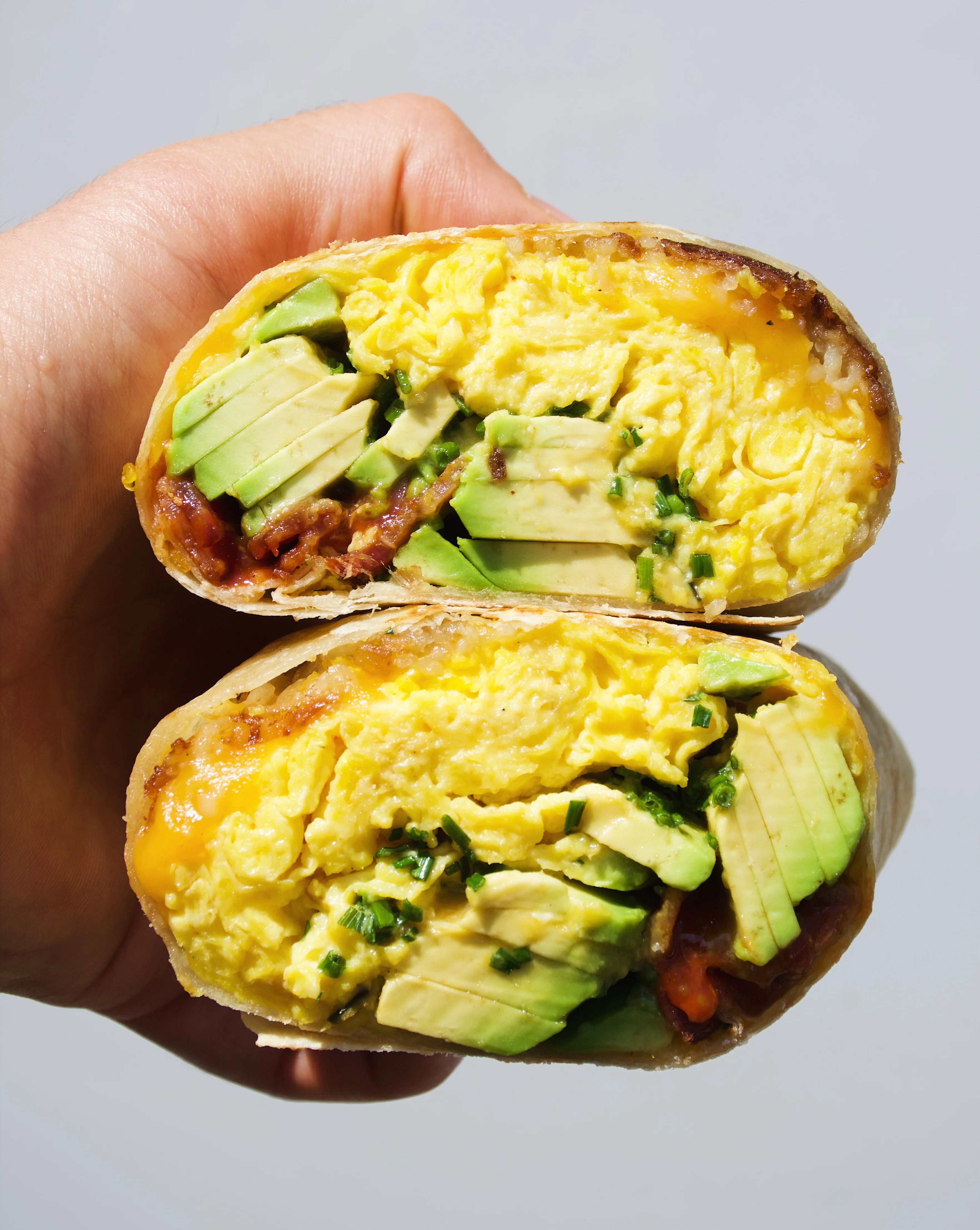 Breakfast burrito with eggs and avocado