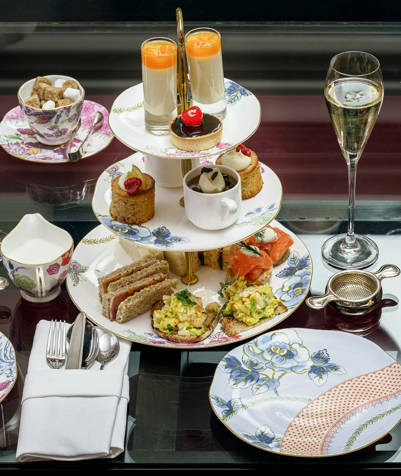 Elegant afternoon tea set with pastries and champagne