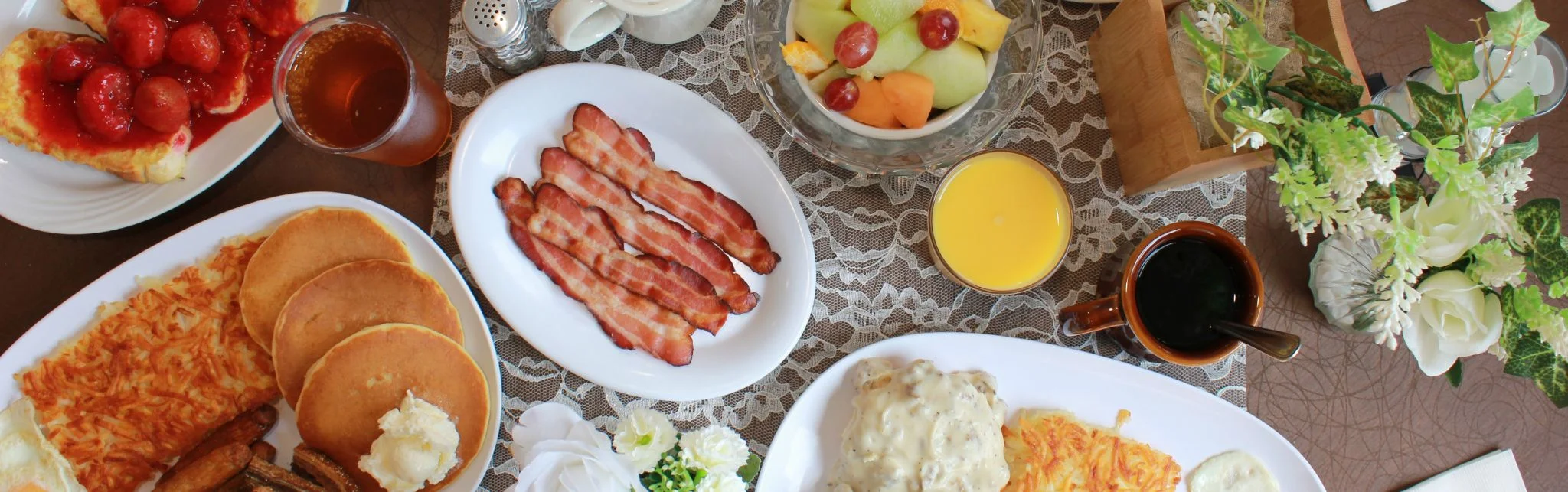 Classic American breakfast with pancakes, bacon, and fresh fruit