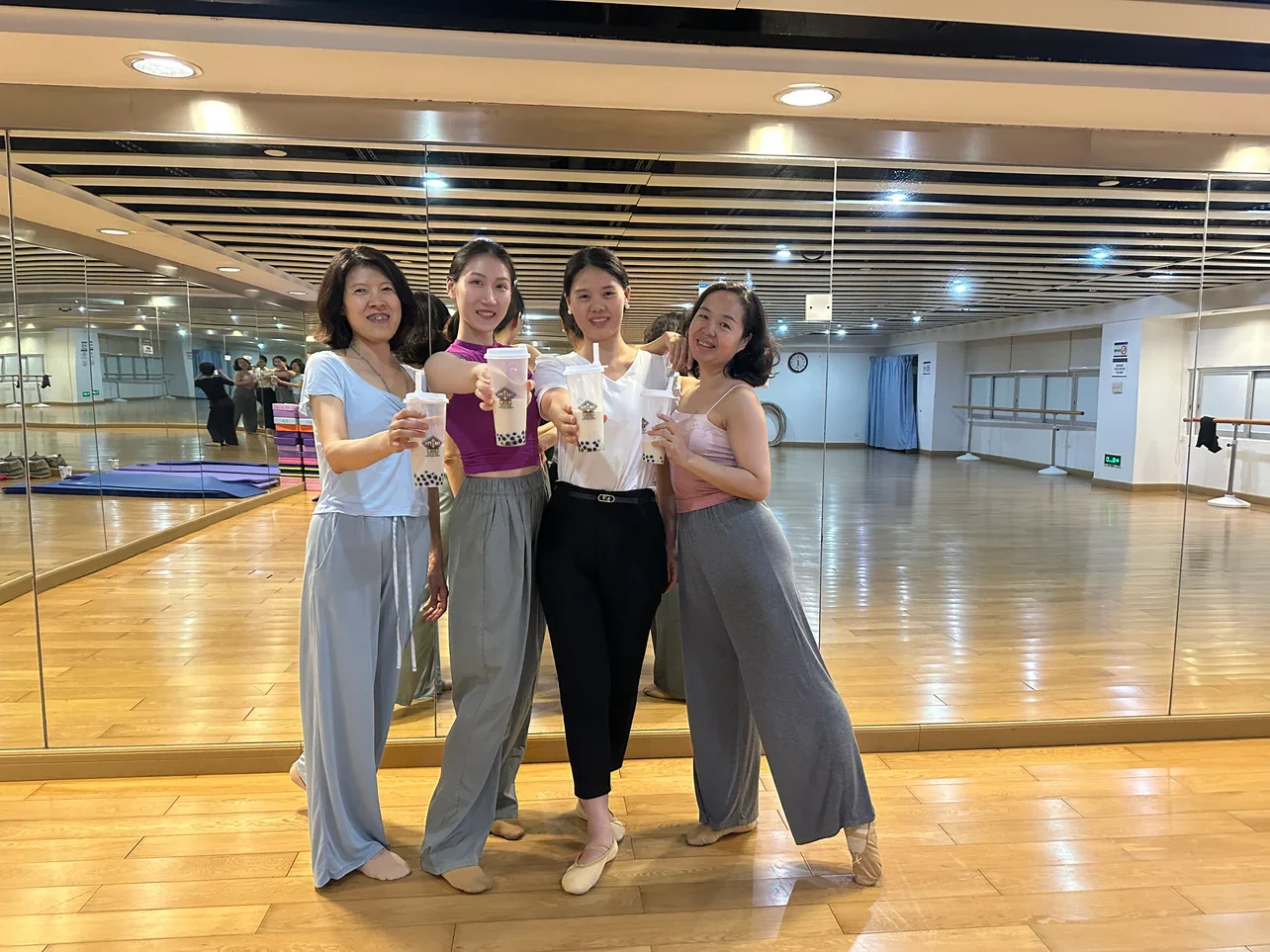 Group of friends enjoying bubble tea in a dance studio