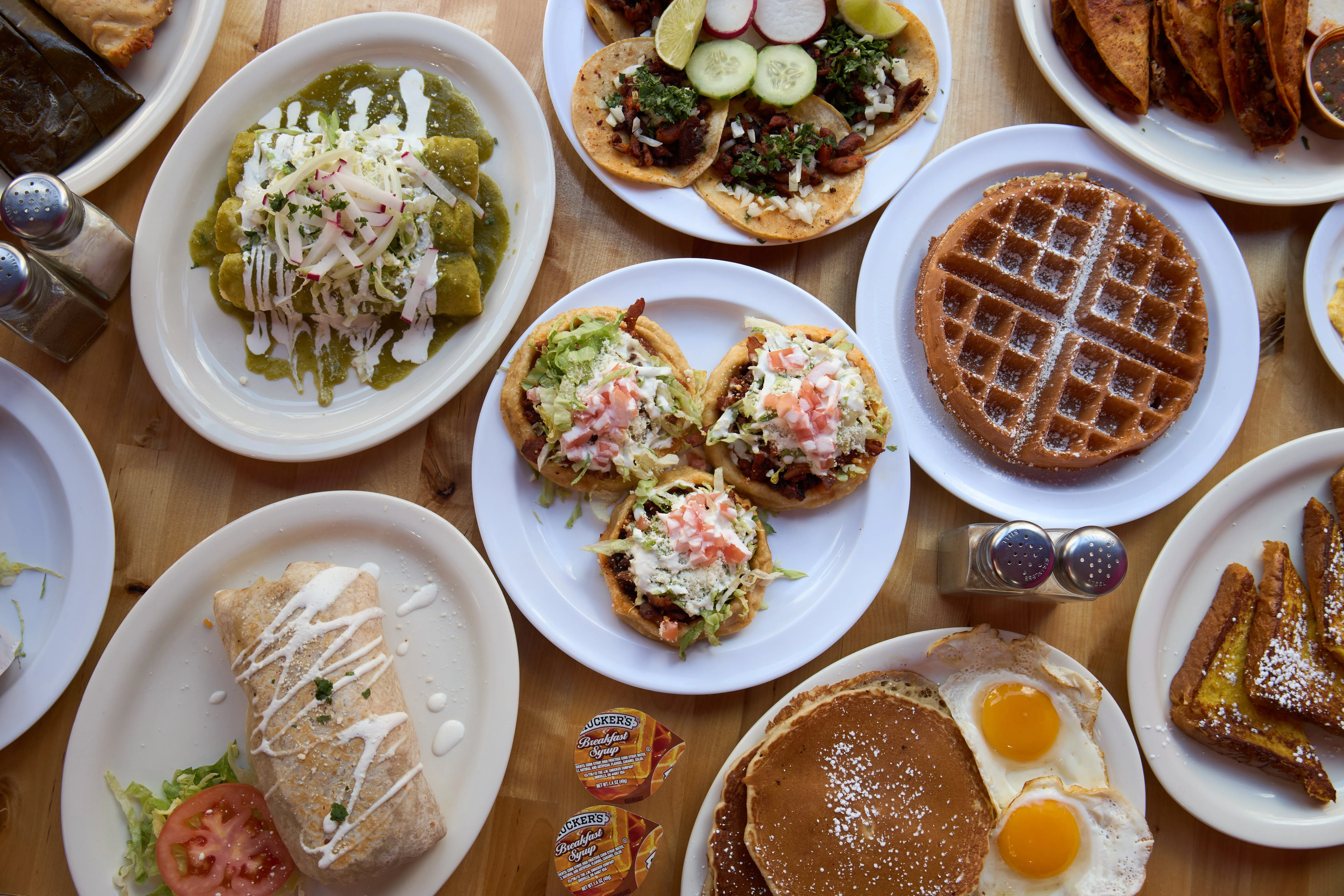 A variety of delicious dishes including tacos, burritos, and waffles.