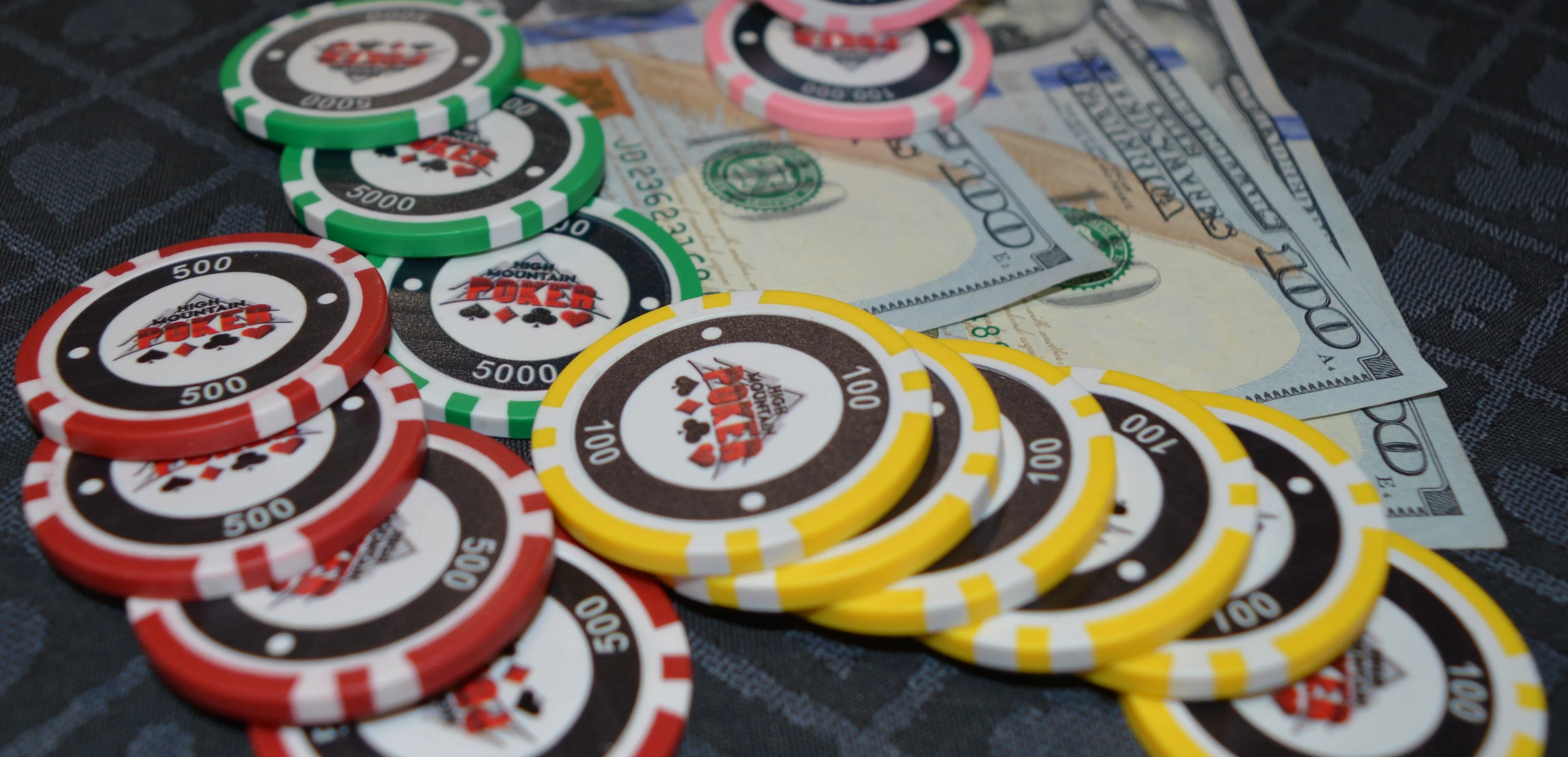 Colorful poker chips and cash on a table