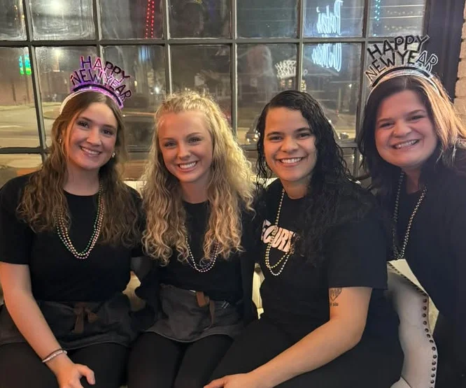 Group of restaurant staff celebrating New Year's Eve together
