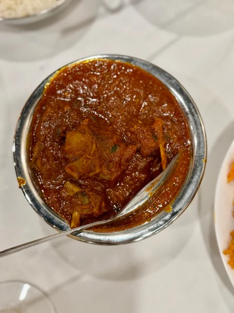 Bowl of aromatic biryani with tender chicken and spices