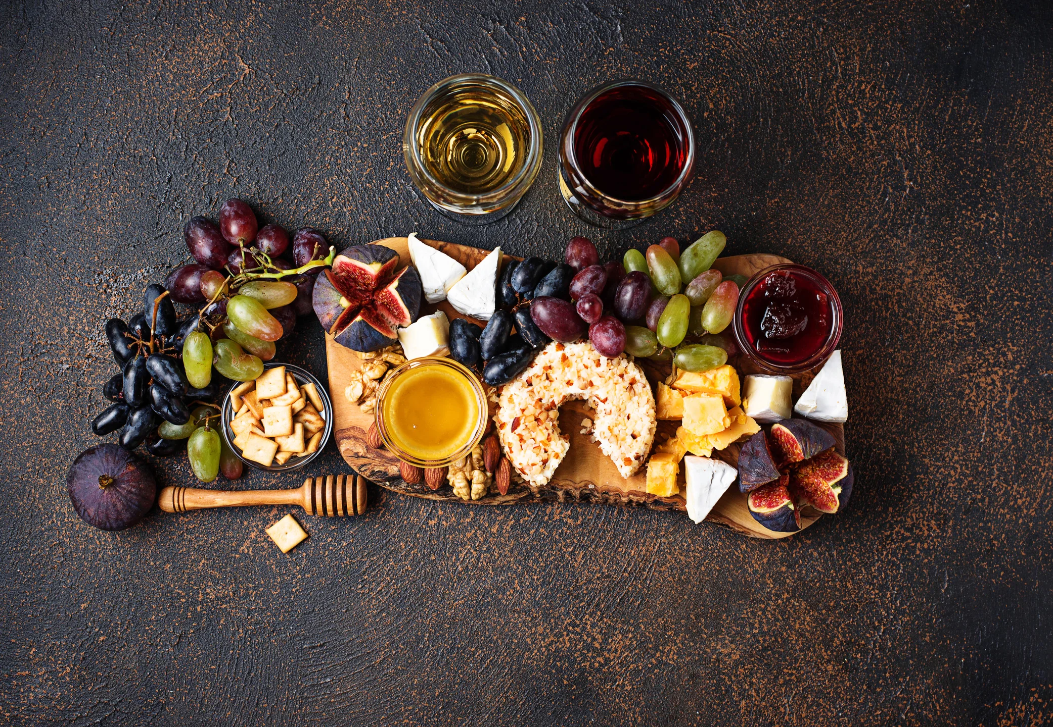 Artisan cheese board with fruits and honey