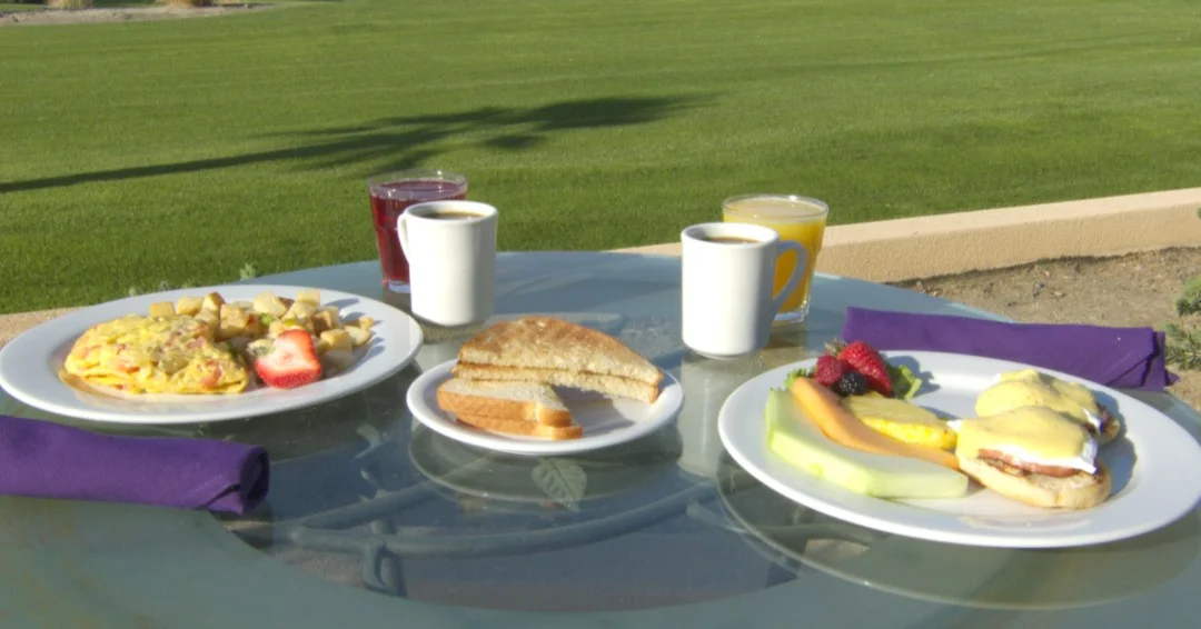 Breakfast spread featuring eggs benedict and omelette
