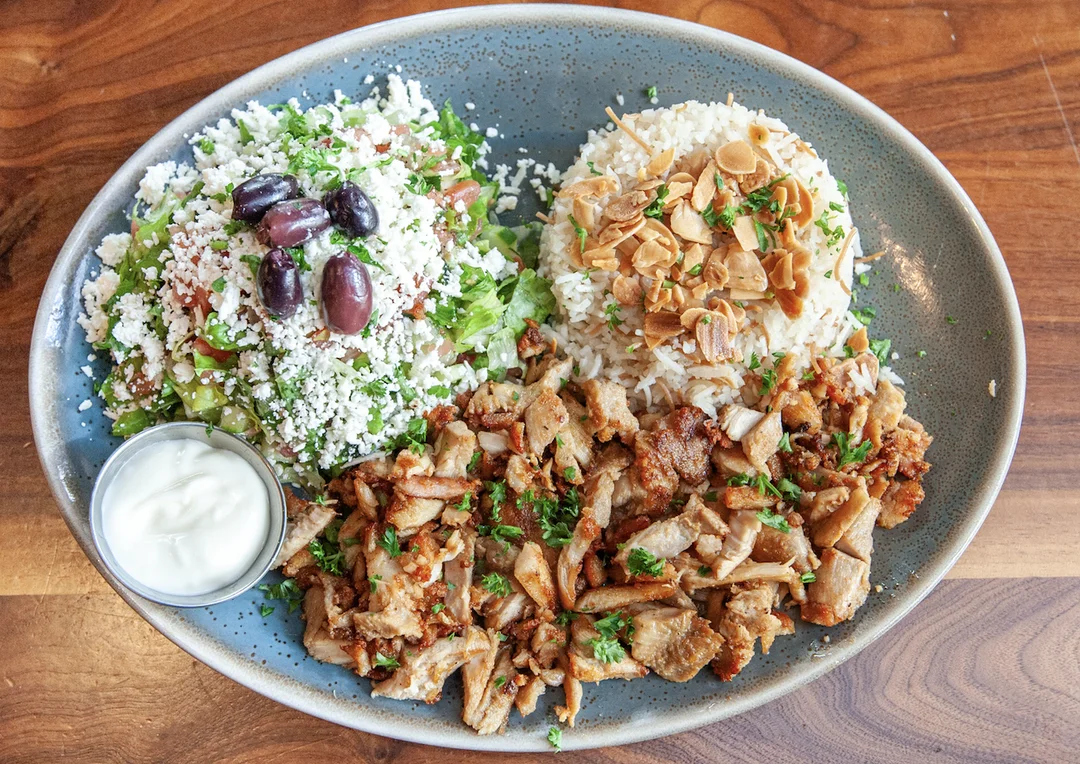 Chicken shawarma platter with tender marinated chicken served with sides.