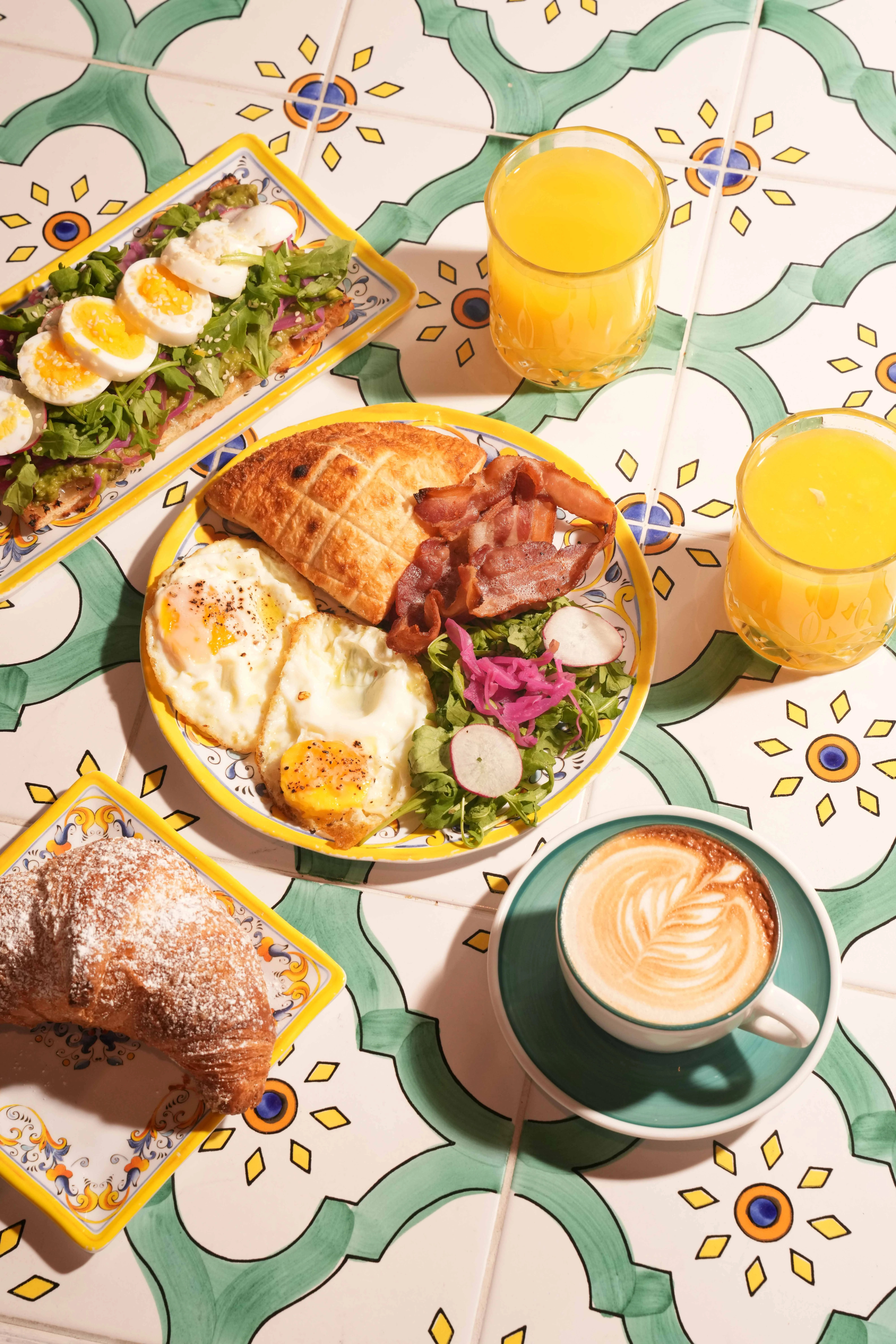 Italian breakfast combo with eggs, bacon, croissant and cappuccino at IT Trattoria